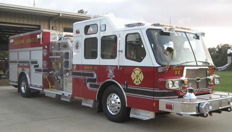 A red and white fire truck parked outside.