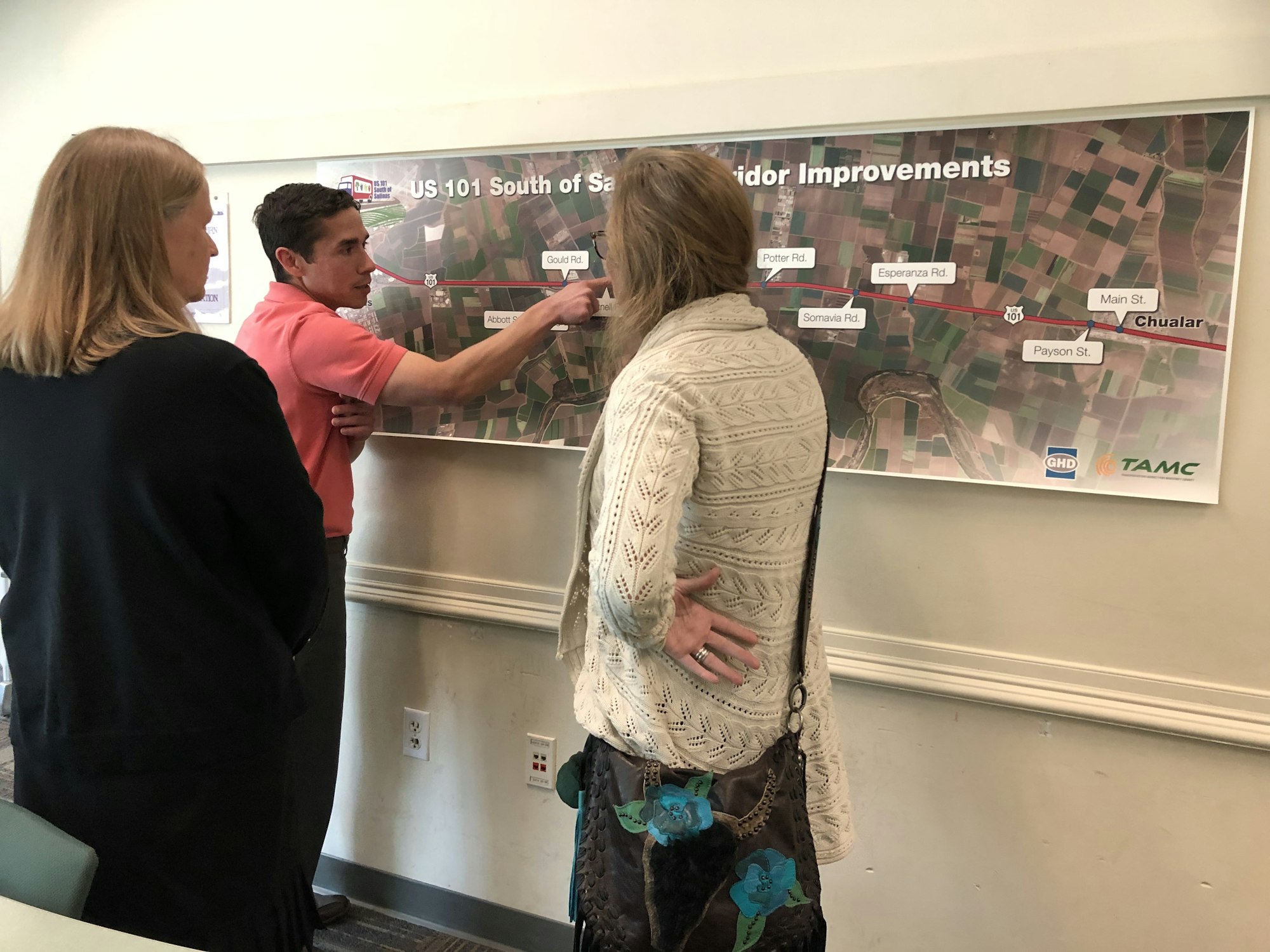 A group discusses a map detailing improvements along US 101 South of Salinas, including various roads and locations.