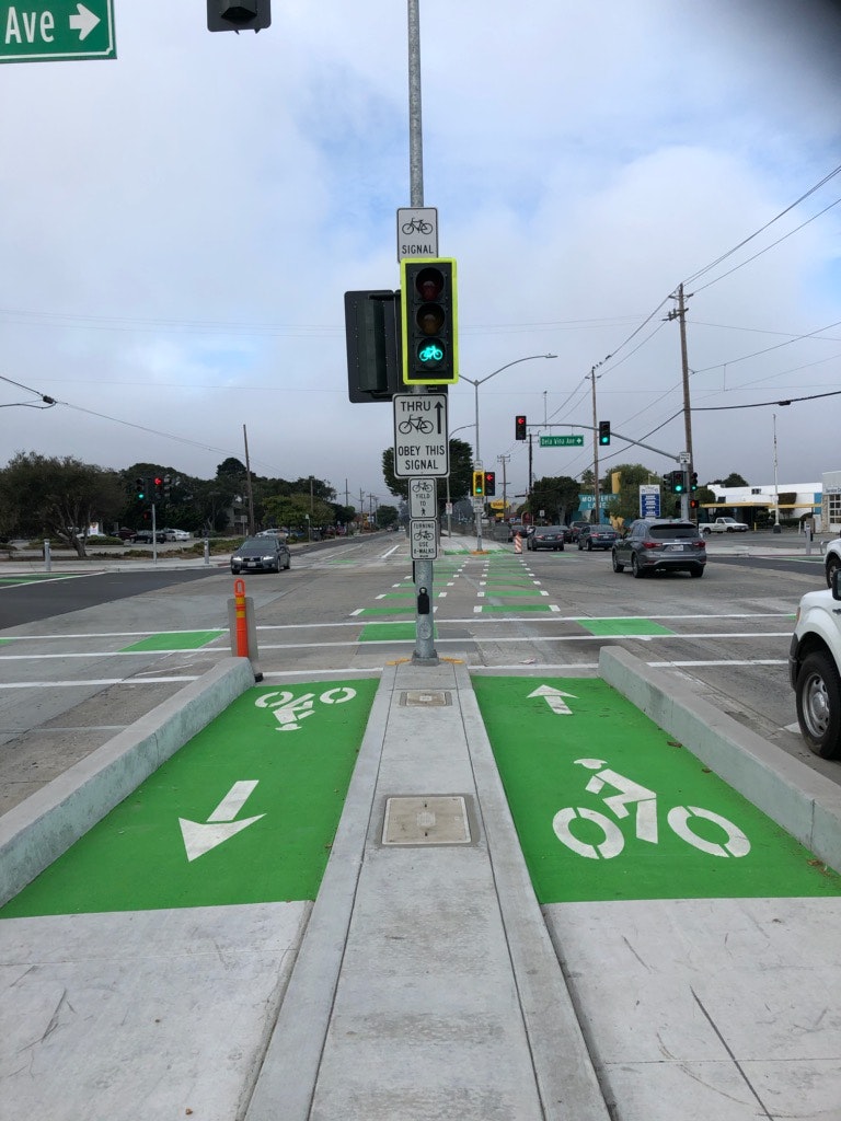 May contain: light, traffic light, road, transportation, car, automobile, vehicle, and intersection