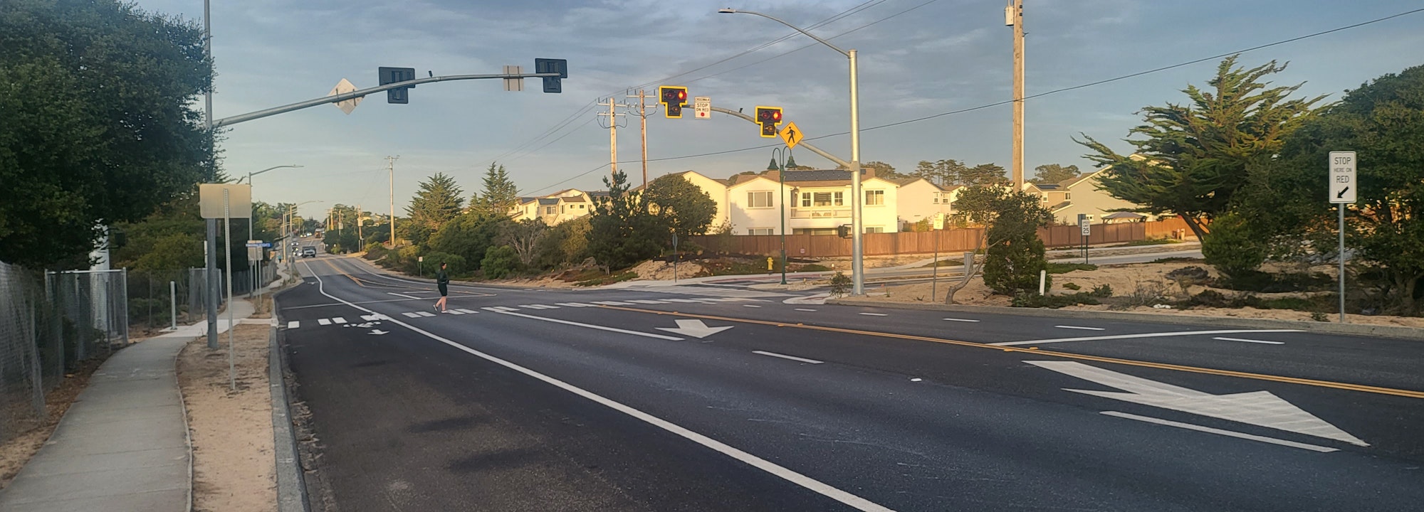 May contain: road, city, street, urban, person, freeway, suburb, light, traffic light, car, transportation, and vehicle
