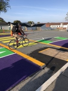 May contain: tarmac, road, bicycle, vehicle, transportation, person, cycling, sport, backpack, and bag