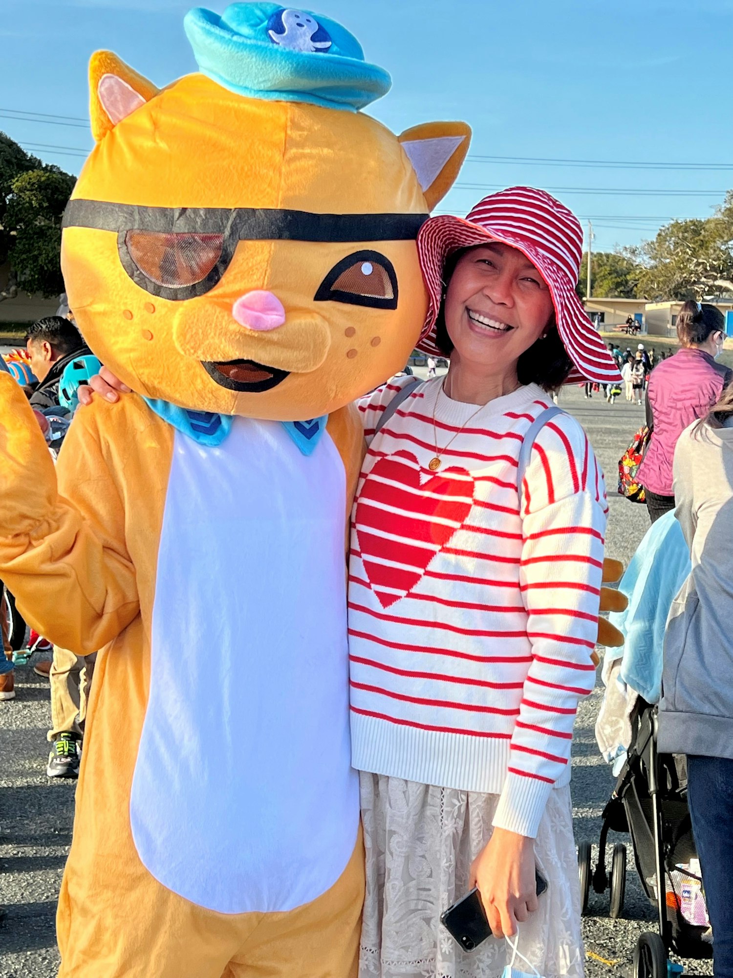 Kwazii mascot with smiling woman