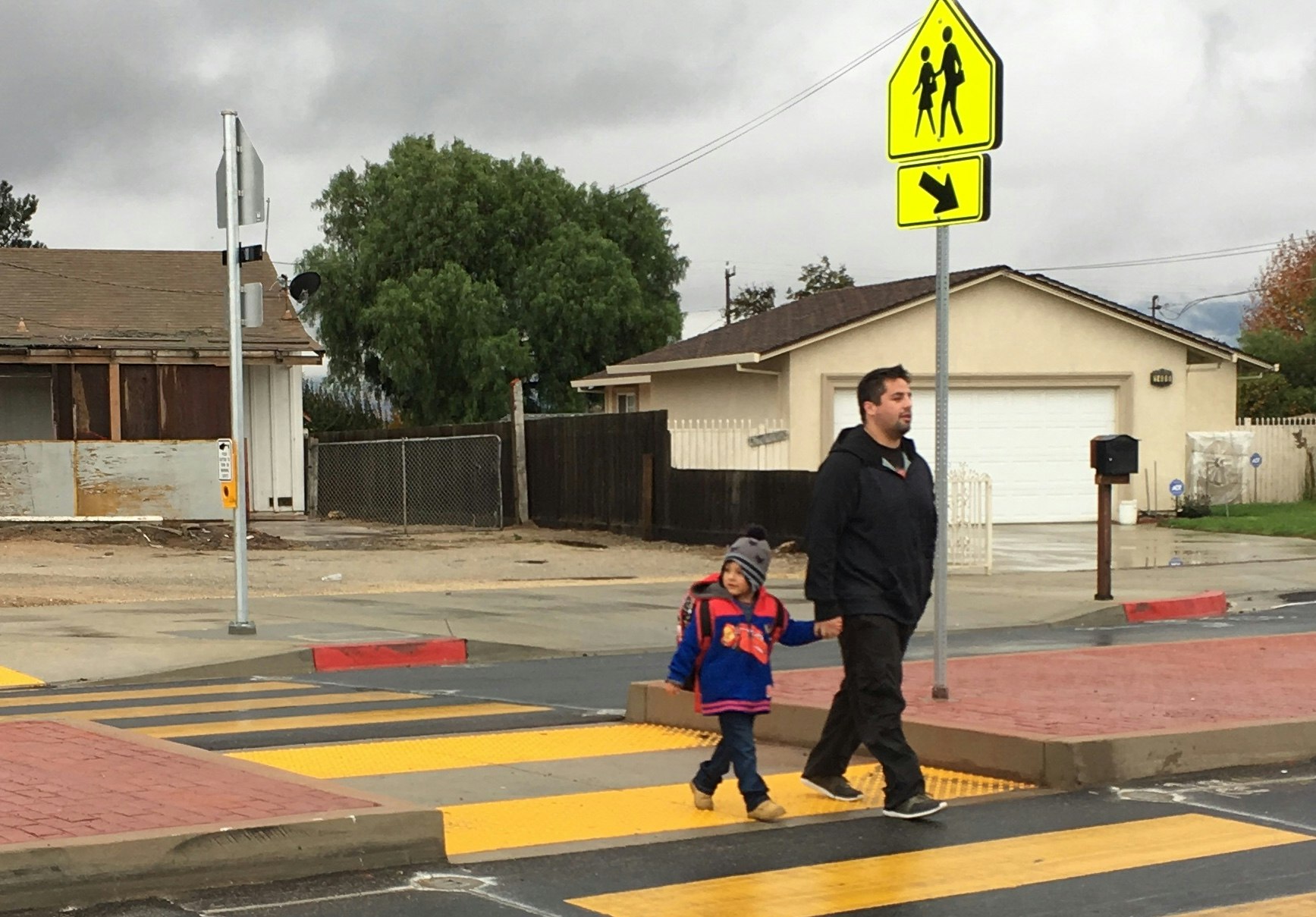 May contain: asphalt, tarmac, road, person, human, shoe, clothing, apparel, footwear, and zebra crossing