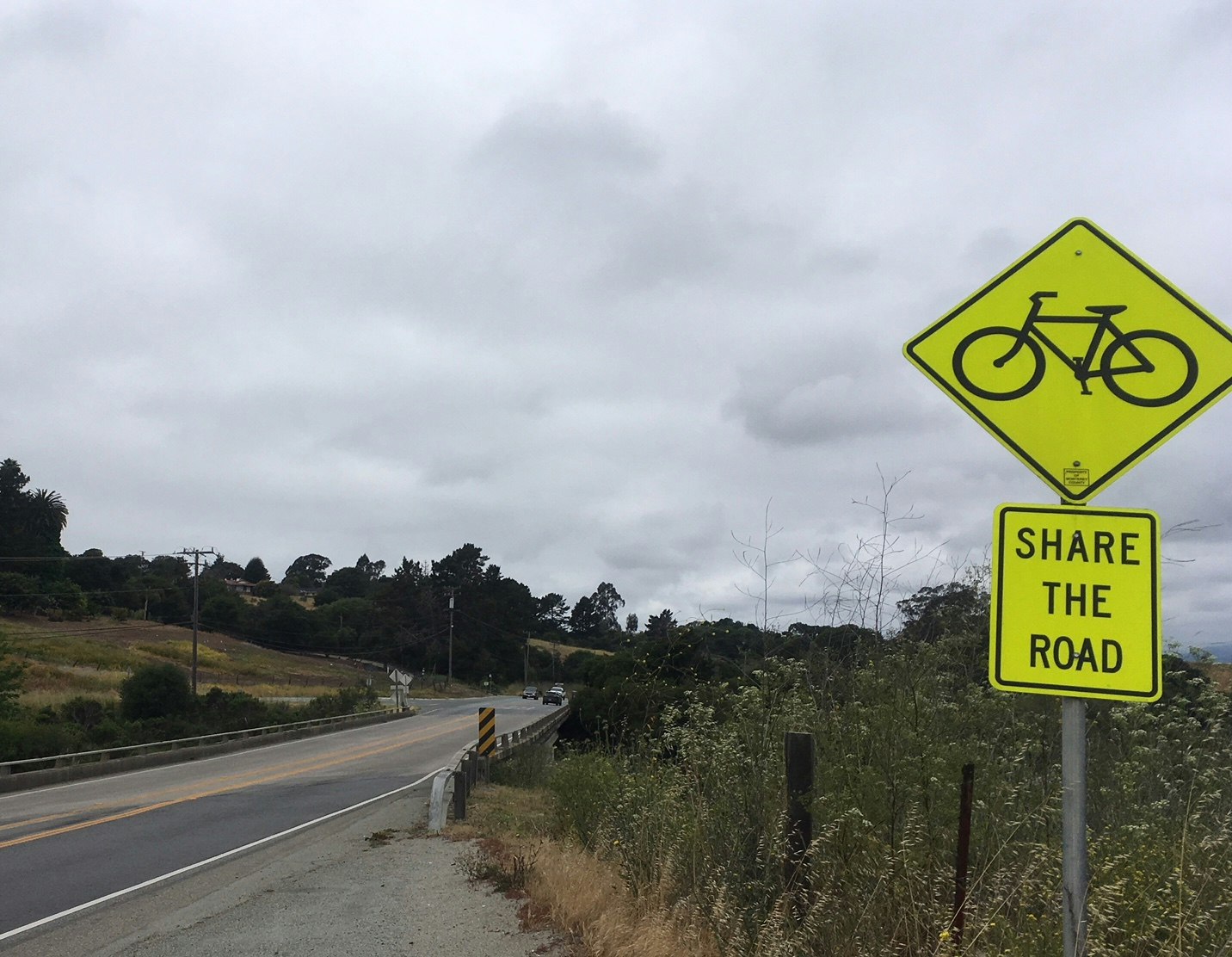 May contain: road, symbol, road sign, and sign