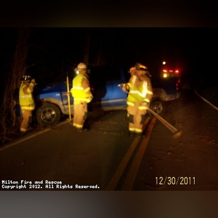 Photo of firefighters helping a disabled vehicle