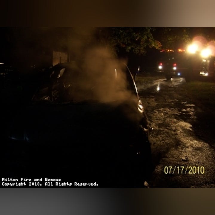 Photo of smoke at night coming from a car