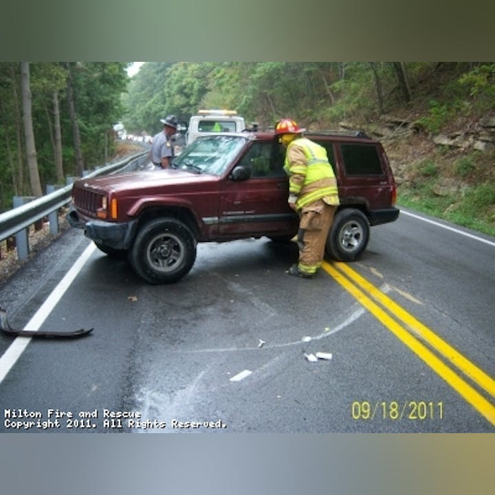 Photo of a firefighter inspecting a vehicle
