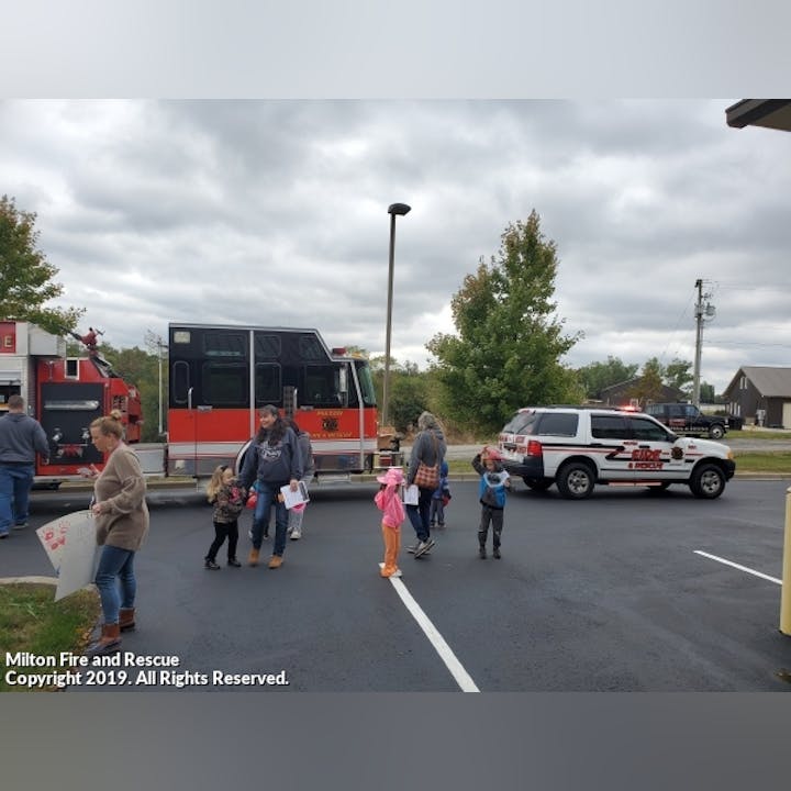 Photo of People gathered by emergency response vehicles