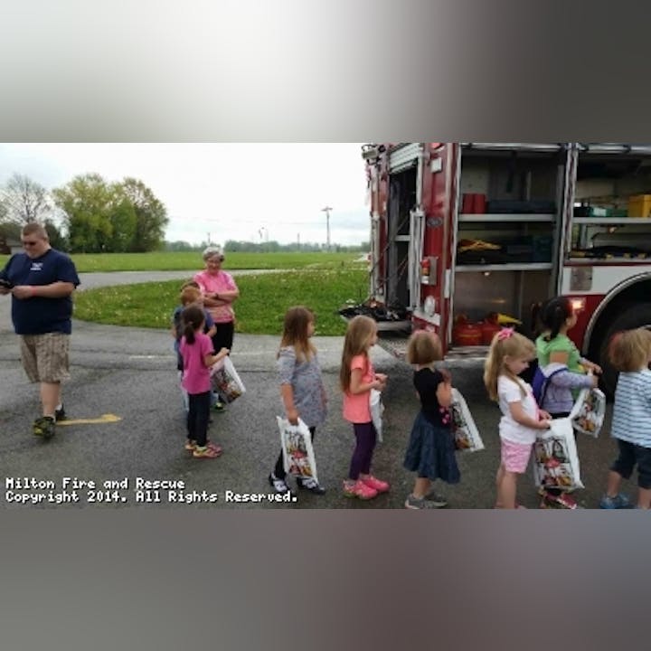 Photo of kids gathered around a fire engine