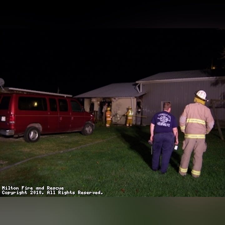 Photo of firefighters outside a home