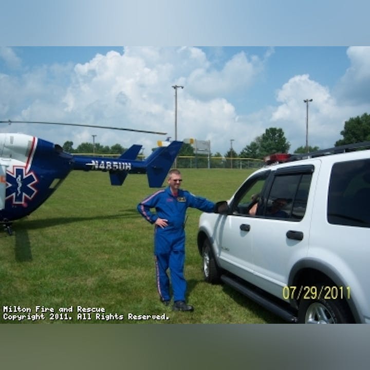 photo of a person in front of a helicopter