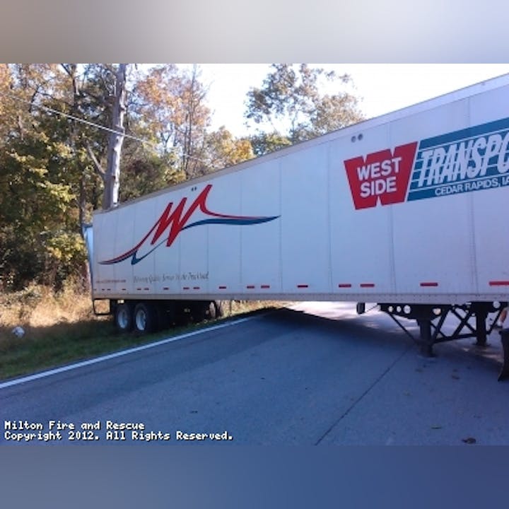 Photo of a semi turned sideways on a roadway