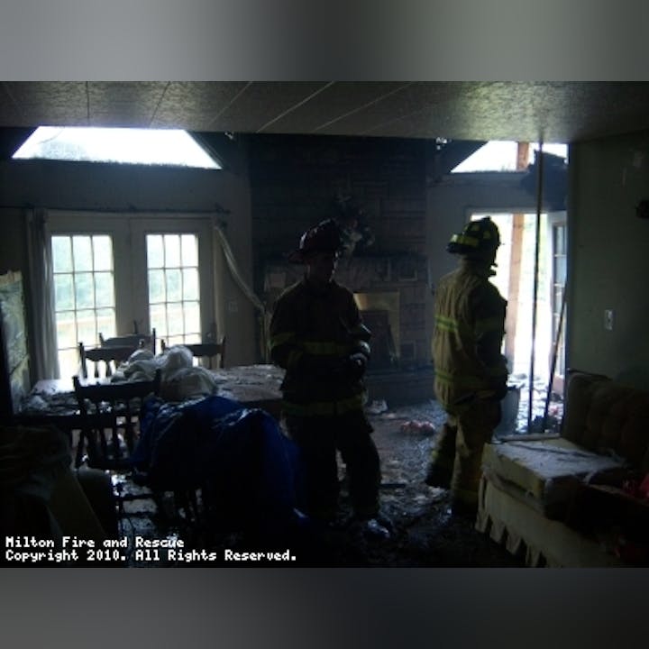 Photo of firefighters in a building after a fire