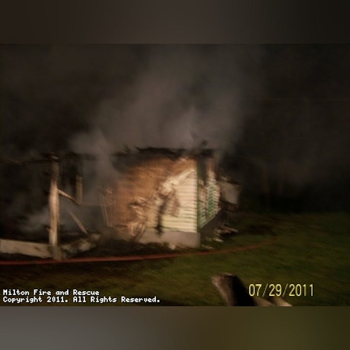 Photo of smoke coming from a structure at night
