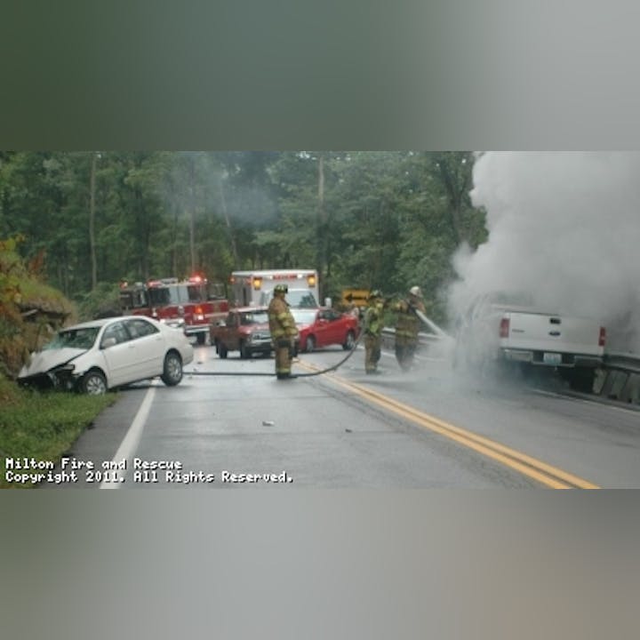 Photo of firefighters working at a car accident