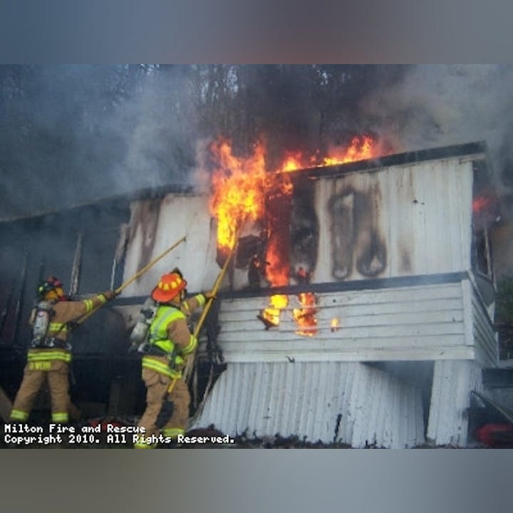 Photo of firefighters putting out a structure fire