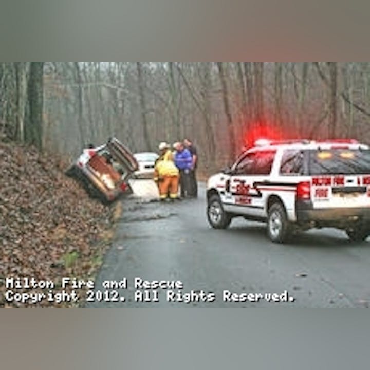 Photo of a car crash. Car up on a slope