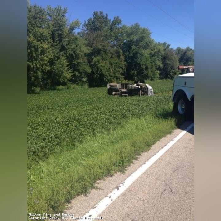 Photo of a grassy area and an overturned vehicle