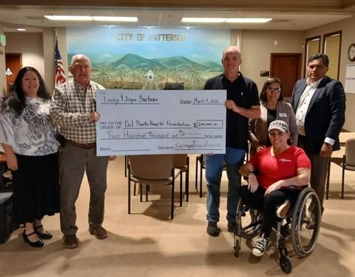 A group poses with a large check for $200,000, donated to the Del Puerto Hospital Foundation.