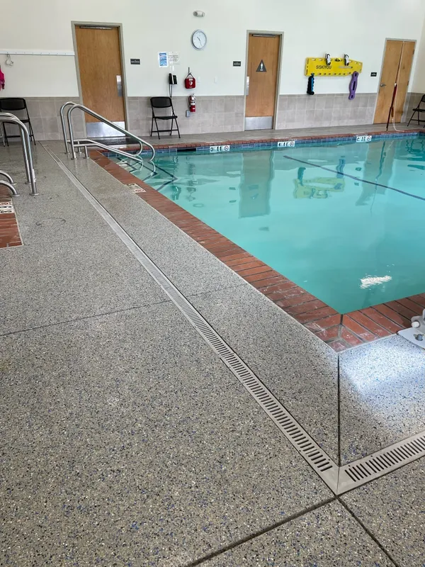 May contain: pool, water, swimming pool, chair, and furniture