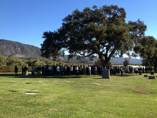 Photo of people gathered in a cemetery