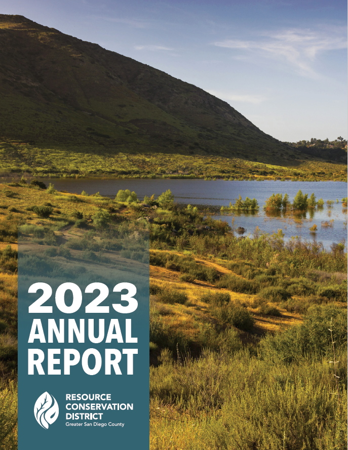 Cover of a 2023 annual report for Resource Conservation District, Greater San Diego County, featuring a landscape with a lake and hills.
