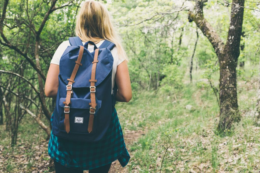 May contain: vegetation, plant, woodland, nature, outdoors, tree, forest, land, person, human, bag, backpack, clothing, and apparel