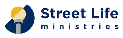 Logo of "Street Life Ministries" with a graphic of an open book resembling streets under a sheltering structure.