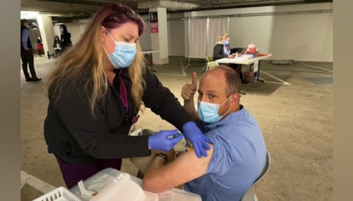 board member getting a vaccine
