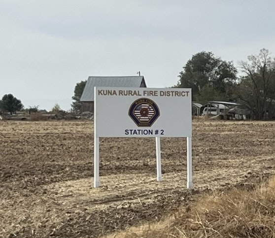 A sign that reads "KUNA RURAL FIRE DISTRICT STATION #2" in a field.
