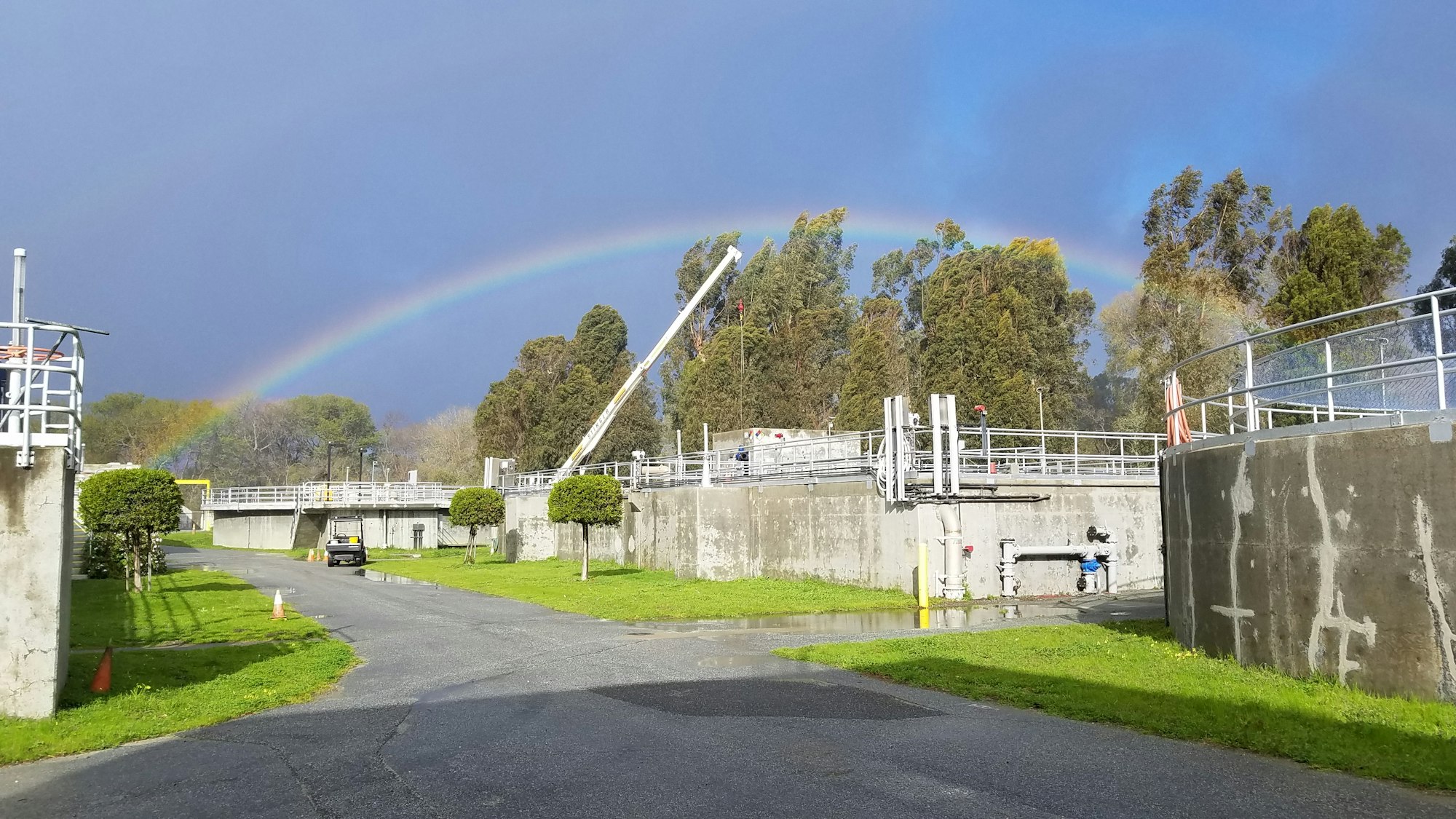 Image of treatment plant with asphalt, tarmac, road, nature, outdoors, with a rainbow