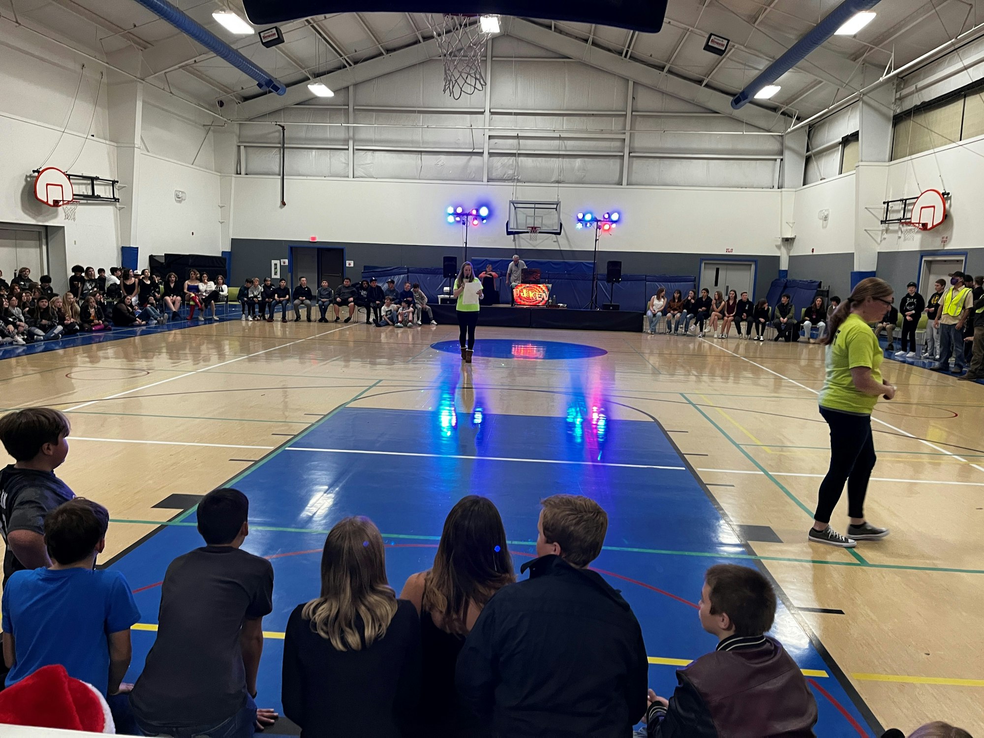 May contain: person, woman, adult, female, male, child, boy, man, volleyball game, volleyball, sport, speaker, electronics, shoe, footwear, clothing, basketball game, and basketball
