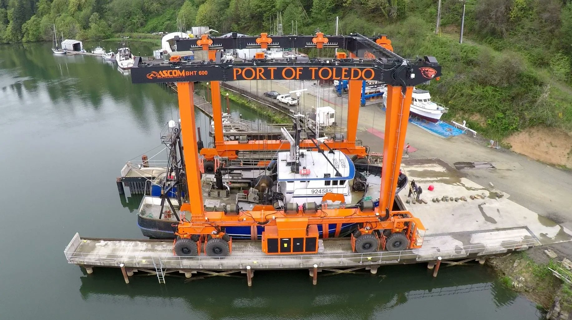 Aerial view of a boat lift system at Port of Toledo with boats docked nearby.
