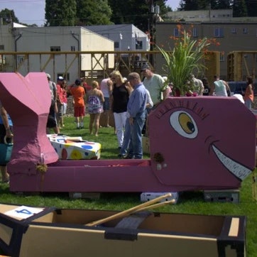 Colorful, whimsical outdoor art installations, with people gathered, possibly at an event or exhibition.