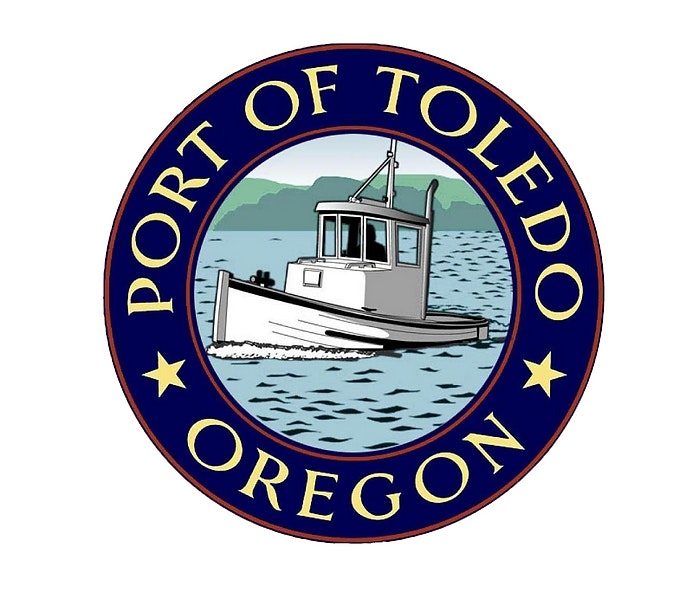 The emblem of the Port of Toledo, Oregon, with a boat on water.