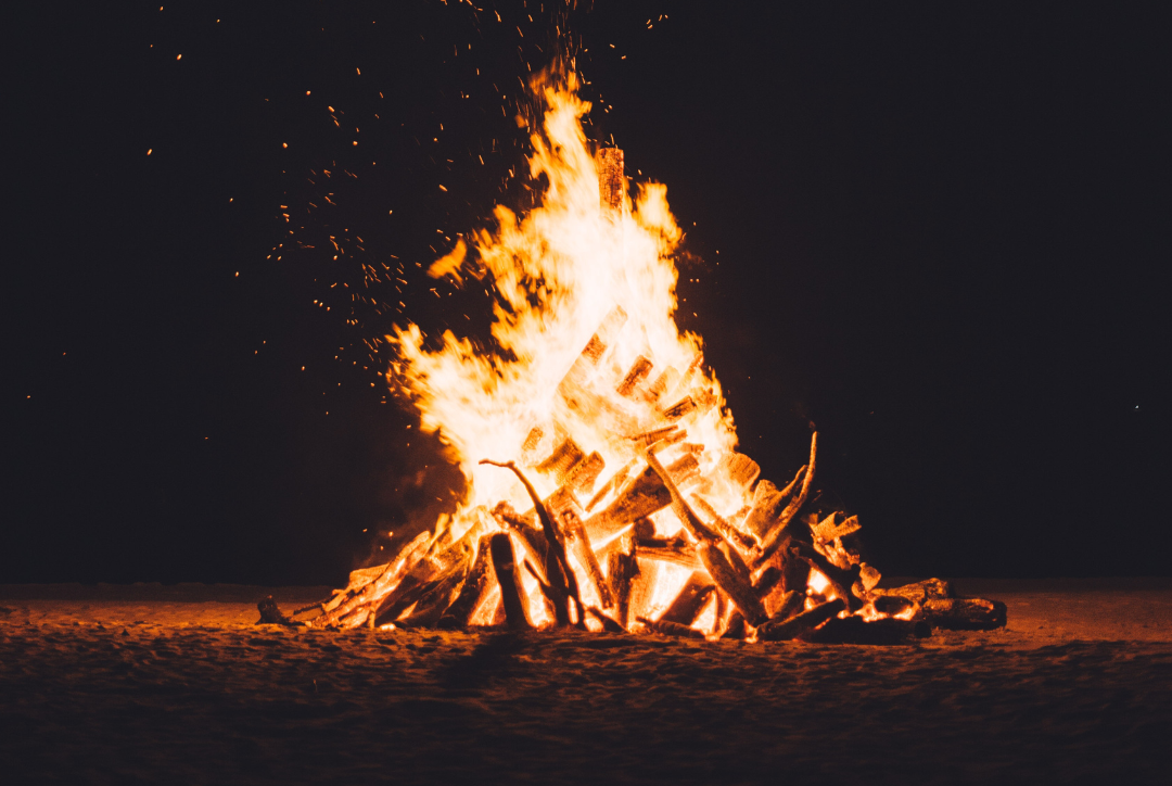 A large bonfire burning brightly in the night.