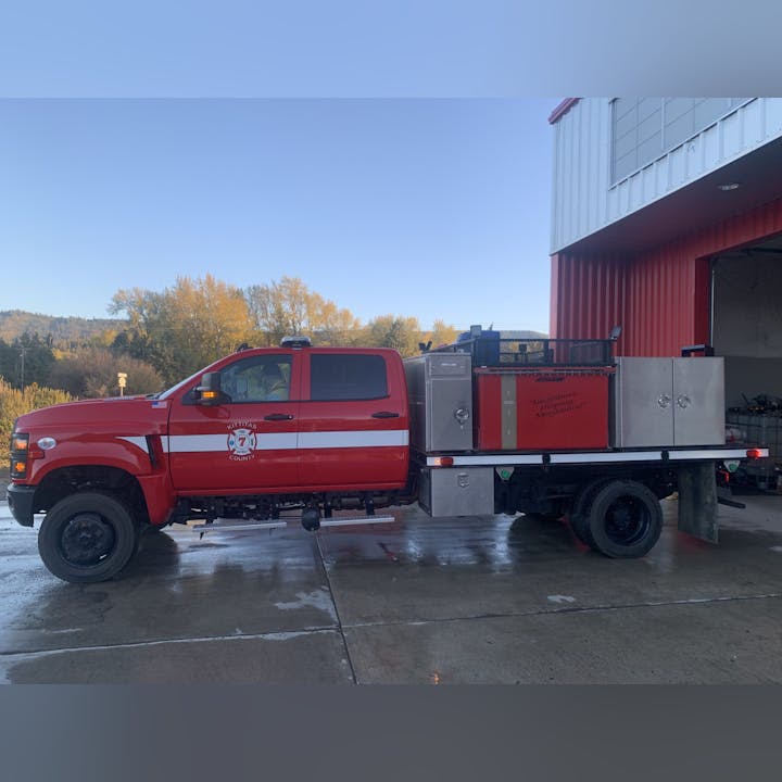 A red fire truck labeled "Kittitas County" parked outside a building.