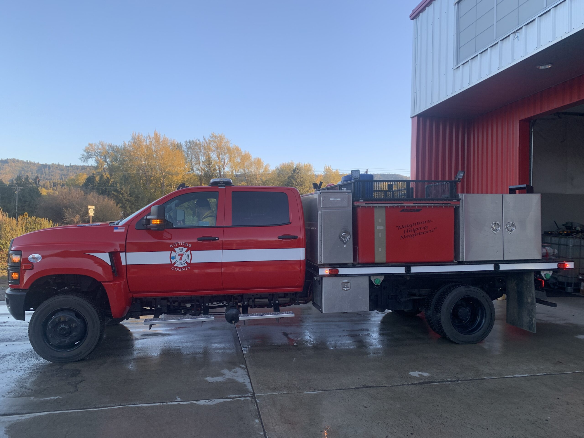 A red fire truck labeled "Kittitas County" parked outside a building.