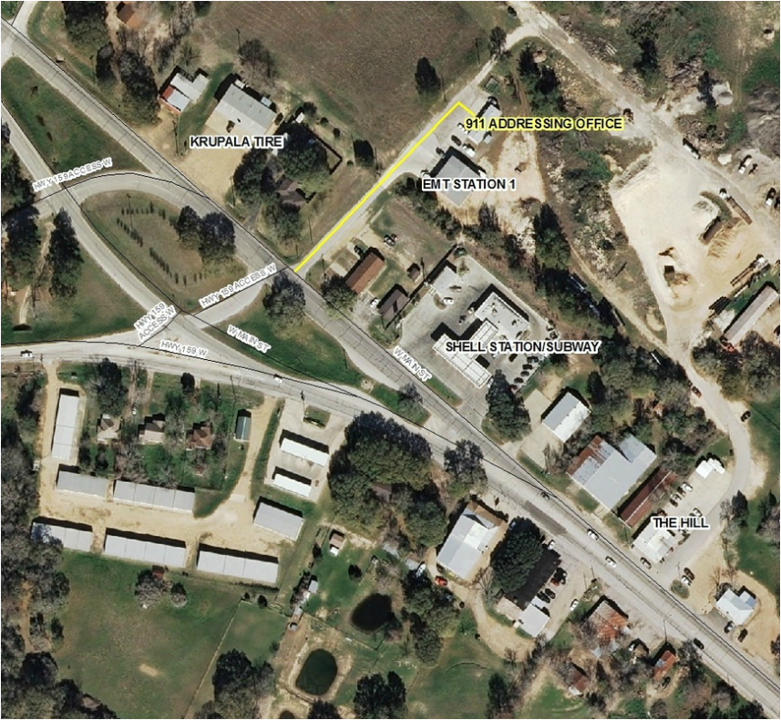 Aerial map view with labels: Tire shop, 911 office, EMT station, Shell station/Subway, and an area named The Hill.