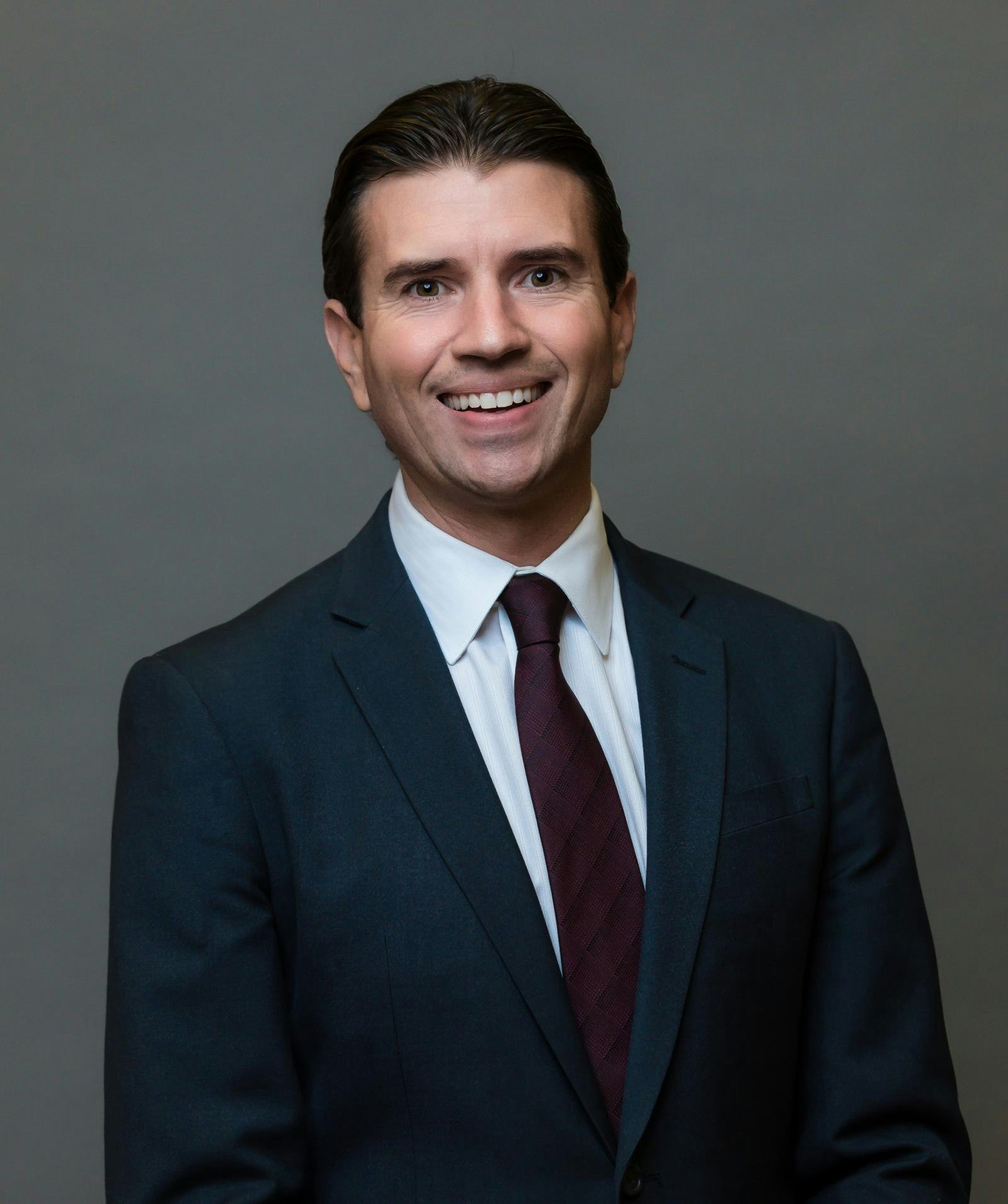 May contain: tie, formal wear, accessories, suit, clothing, blazer, coat, jacket, necktie, head, person, face, portrait, photography, man, adult, male, smile, and happy