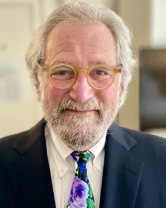 May contain: accessories, formal wear, tie, beard, face, head, person, adult, male, man, clothing, suit, photography, portrait, glasses, and necktie