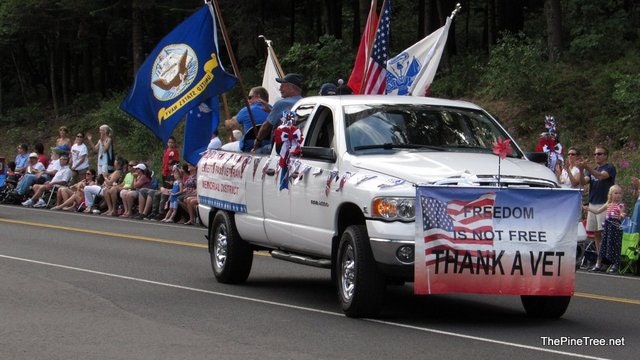 May contain: flag, license plate, transportation, vehicle, pickup truck, truck, person, clothing, and hat
