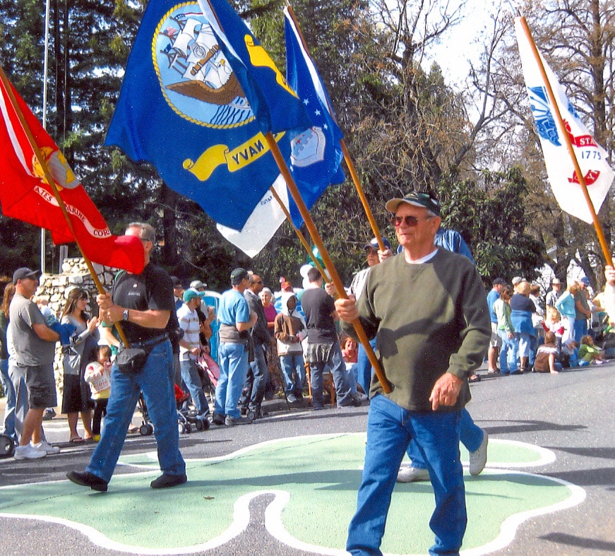 May contain: people, person, clothing, pants, adult, male, man, jeans, marching, footwear, shoe, baseball cap, cap, and hat