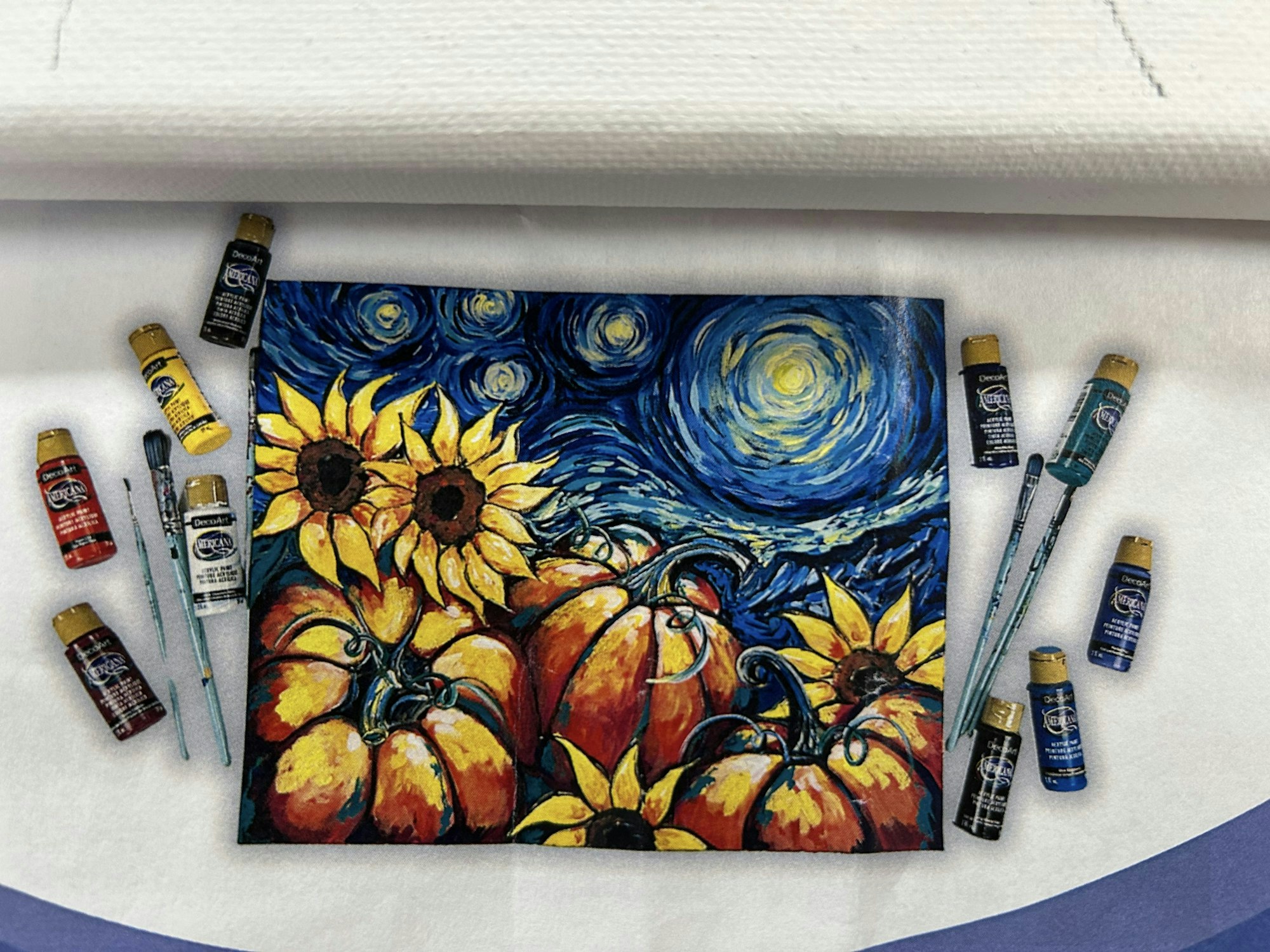A painting combining sunflowers and pumpkins in a "Starry Night" style, surrounded by paint bottles and brushes.
