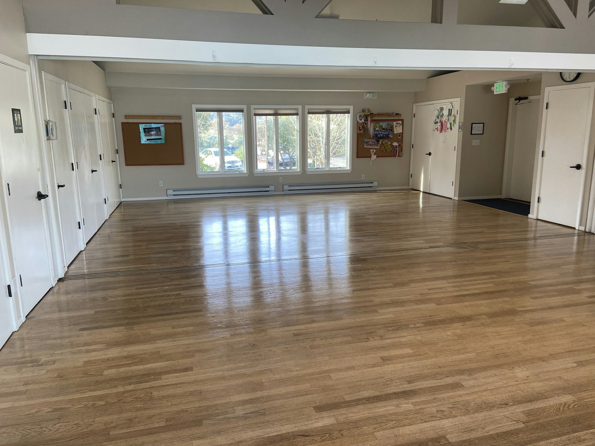 An room with a wooden floor and cabinets.