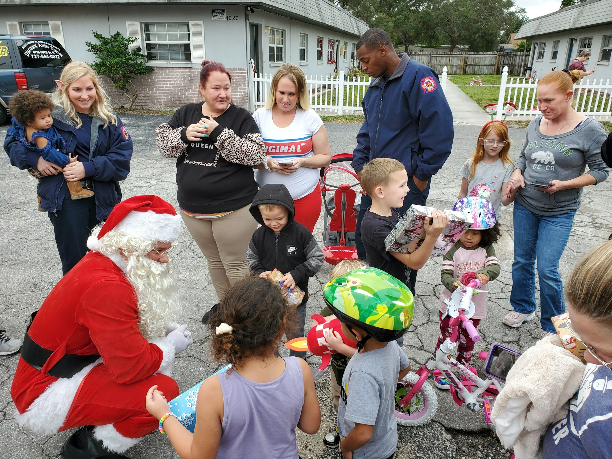 Santa talks to children while delivering gifts