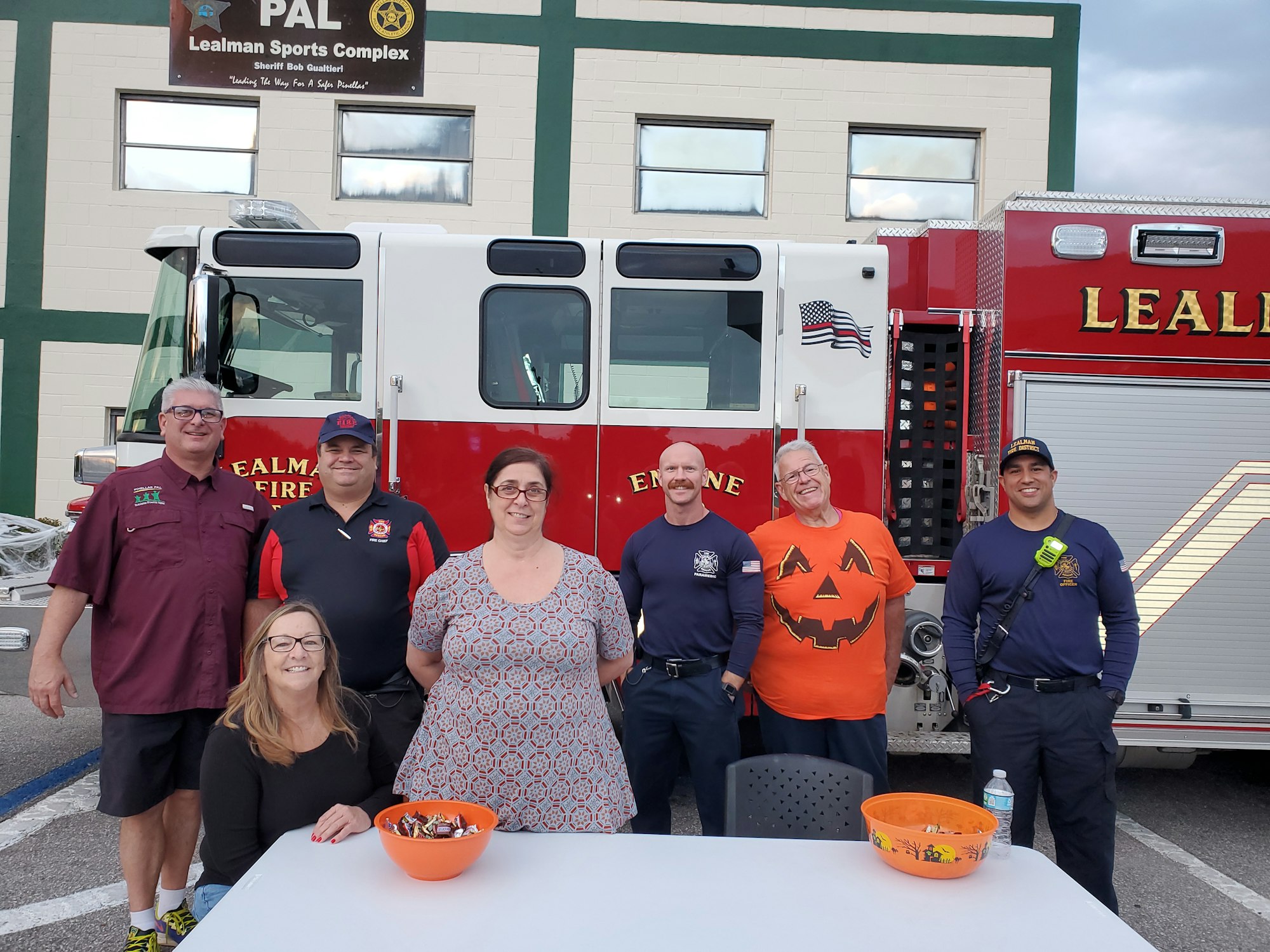 People in front of a fire truck
