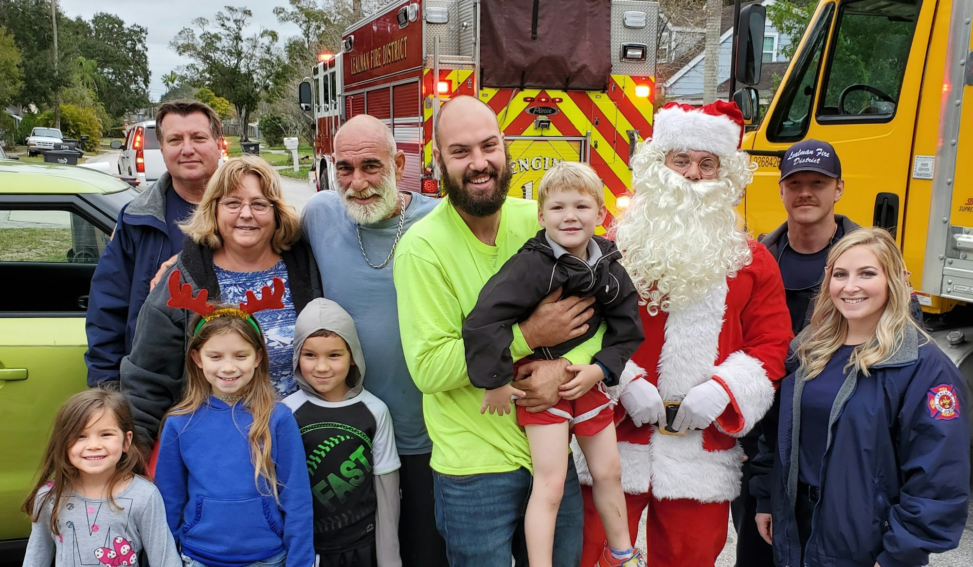 Picture of Santa with family during delivery, smiling kids