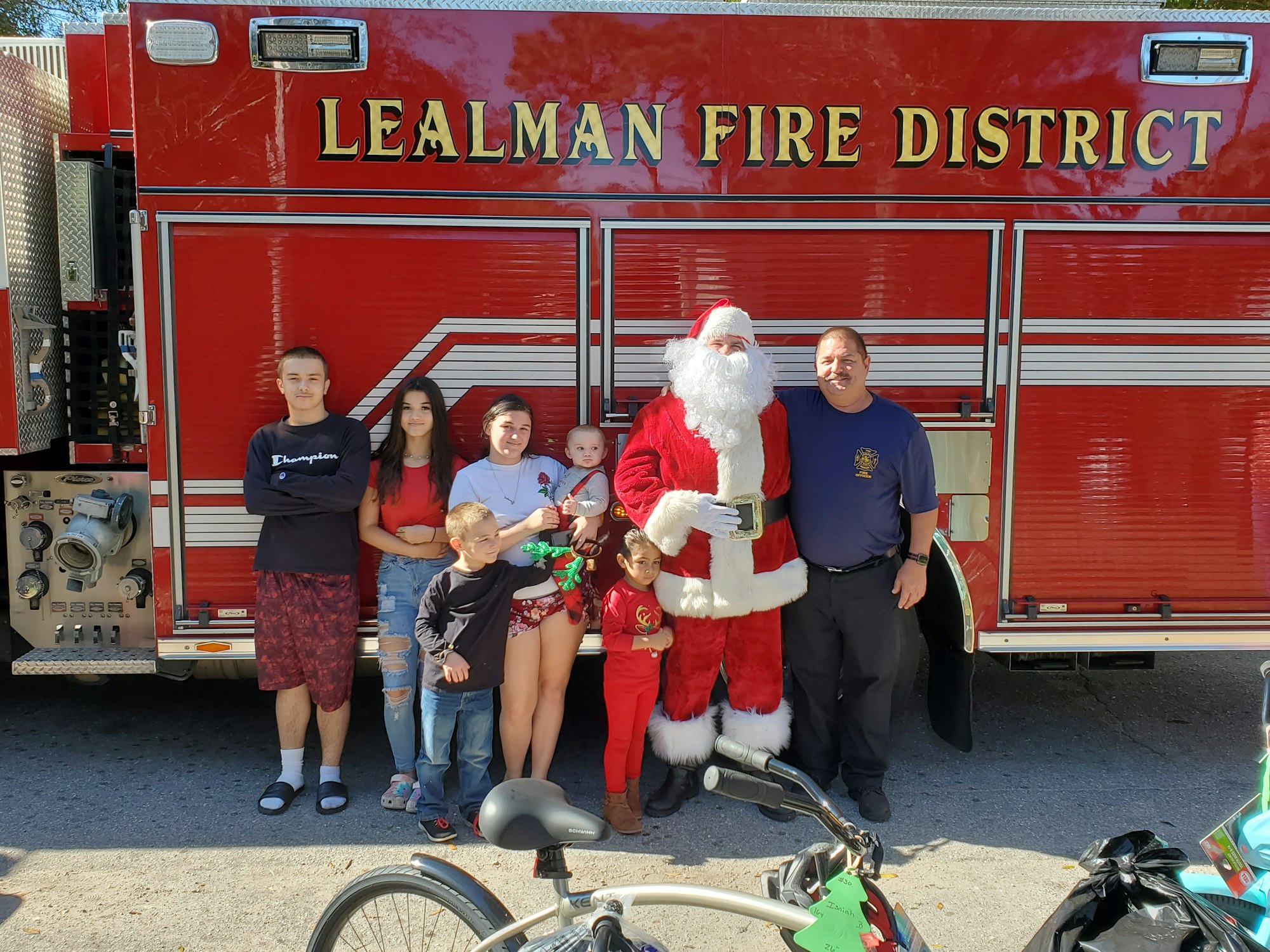 People in front of a fire truck with Santa