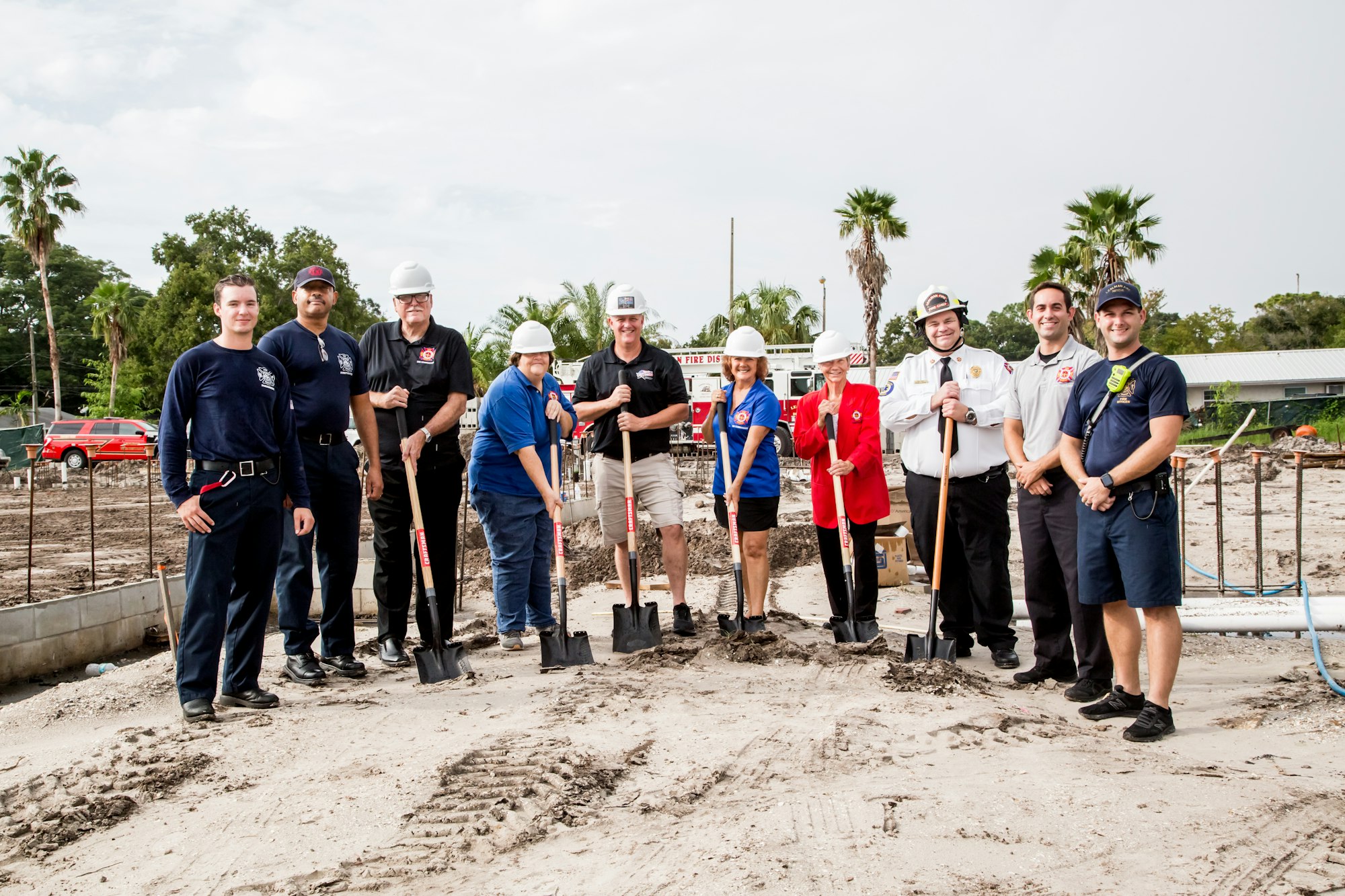 Men and Women pose for a picture, some with shovels 09/16/2021
